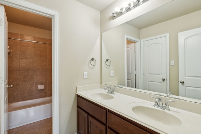 bathroom featuring tile patterned flooring, vanity, and tiled shower / bath combo