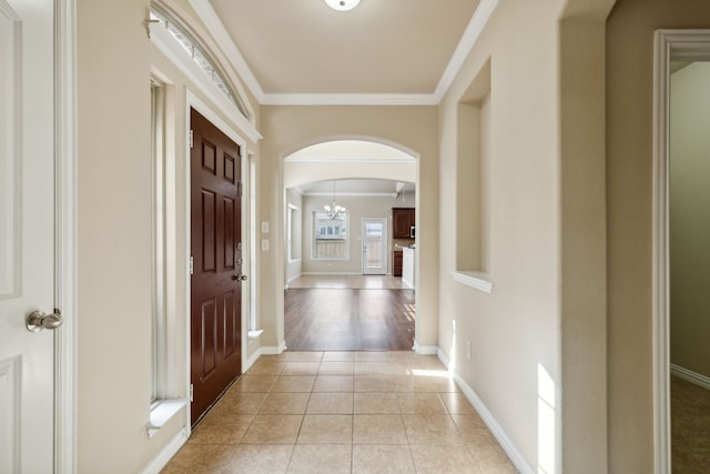 hall with light tile patterned floors and crown molding