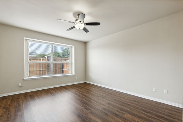 unfurnished room with ceiling fan and dark hardwood / wood-style flooring