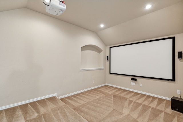 carpeted cinema featuring vaulted ceiling