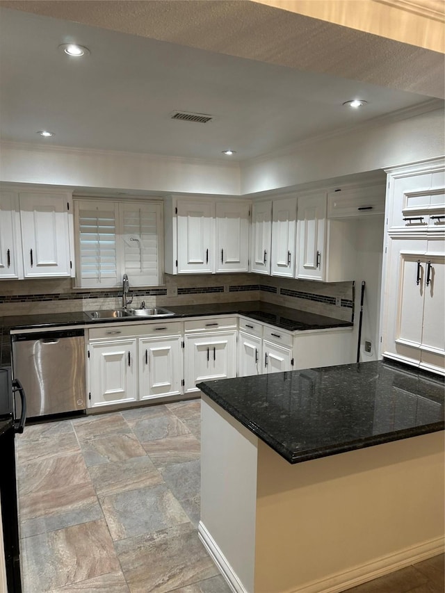 kitchen with sink, stainless steel dishwasher, dark stone counters, decorative backsplash, and white cabinets