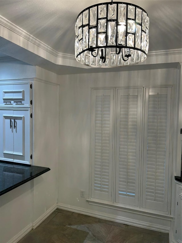 unfurnished dining area featuring crown molding and a notable chandelier