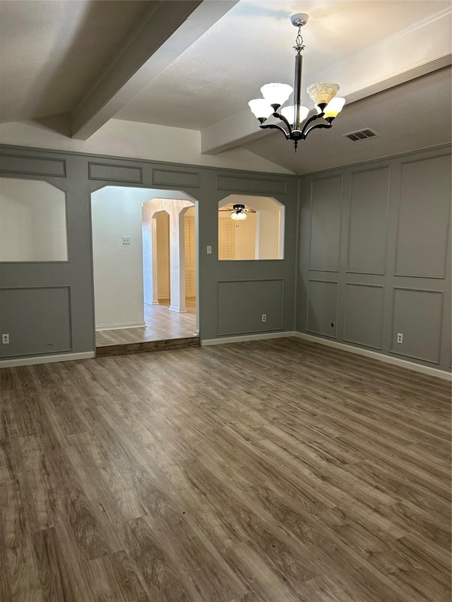 interior space featuring dark hardwood / wood-style flooring, beamed ceiling, and ceiling fan with notable chandelier