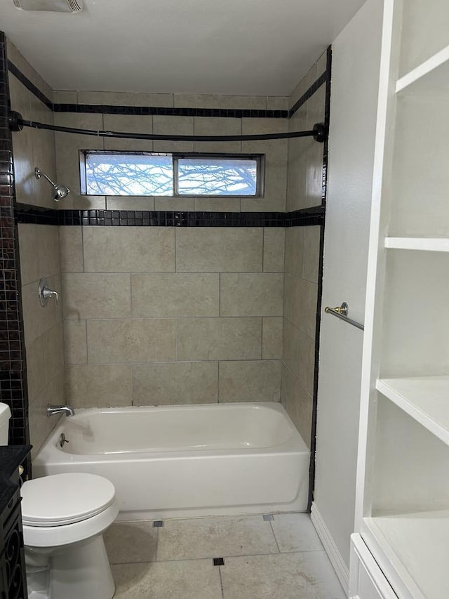 full bathroom featuring vanity, tiled shower / bath combo, and toilet