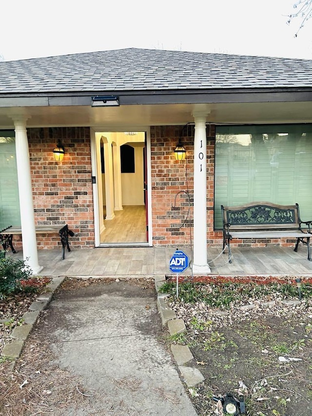 view of exterior entry with covered porch