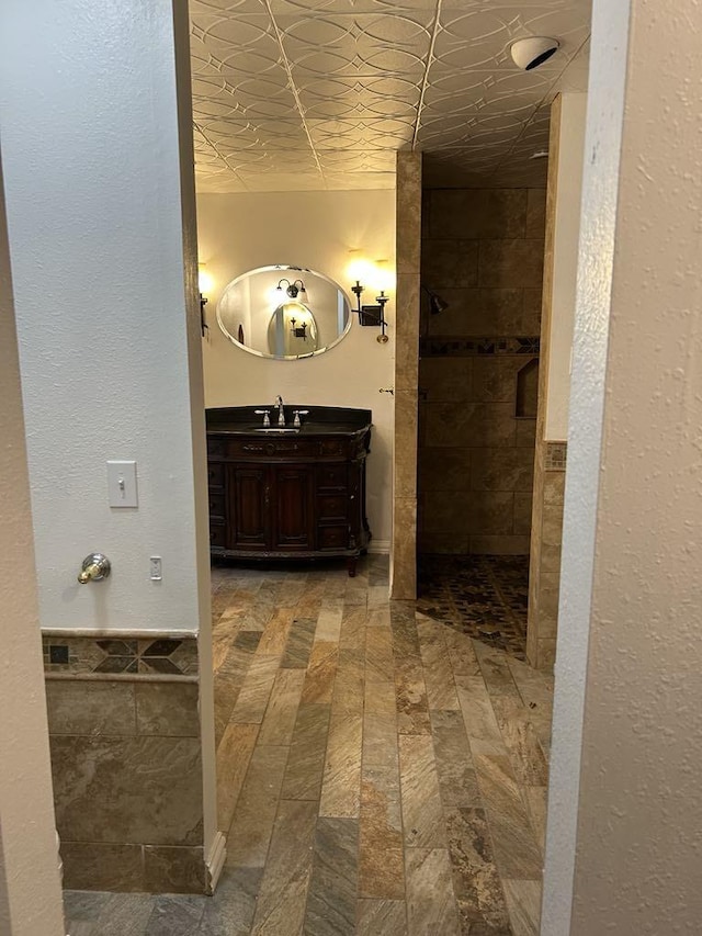 bathroom with vanity and a shower