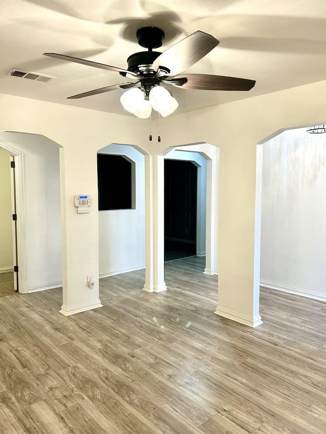 unfurnished room featuring hardwood / wood-style floors and ceiling fan