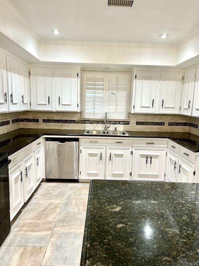 kitchen with dishwasher, dark stone counters, white cabinets, sink, and decorative backsplash