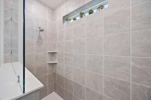 bathroom with a tile shower