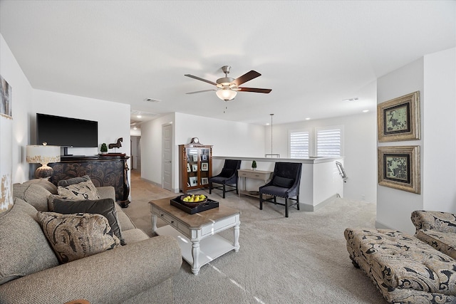 living room featuring light carpet and ceiling fan