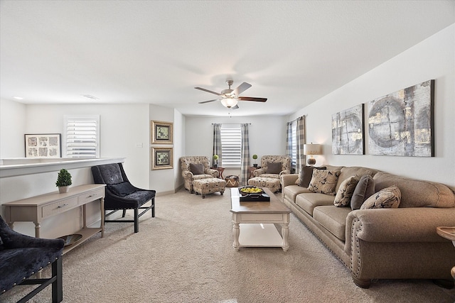 carpeted living room featuring a wealth of natural light and ceiling fan