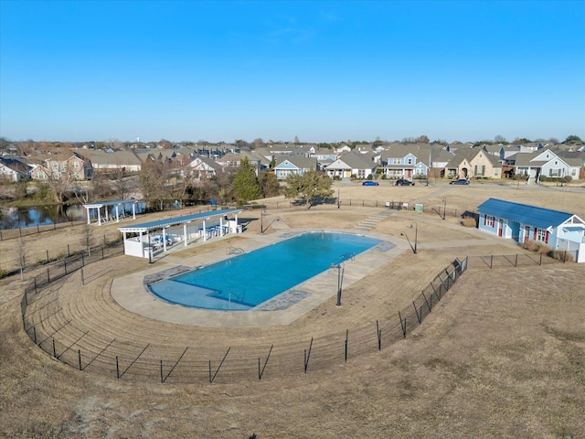 view of pool with a water view and a patio