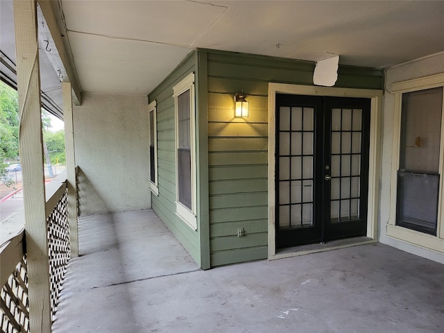 property entrance with a porch and french doors