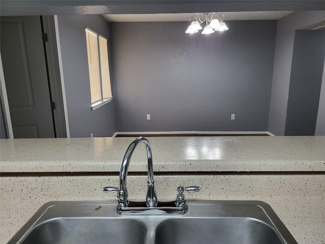 kitchen featuring a chandelier and sink