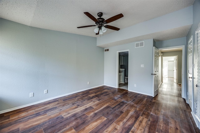 unfurnished room with a textured ceiling, ceiling fan, and dark hardwood / wood-style floors