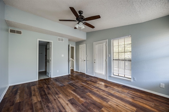 empty room featuring ceiling fan, dark hardwood / wood-style flooring, and a textured ceiling