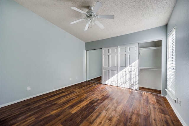 unfurnished bedroom with a textured ceiling, dark hardwood / wood-style floors, and ceiling fan