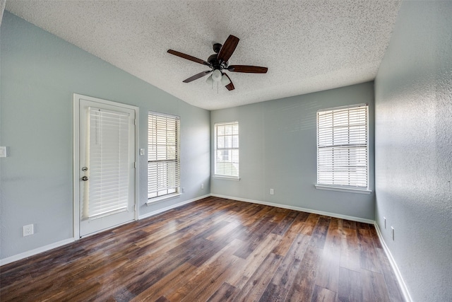 unfurnished room with a textured ceiling, dark hardwood / wood-style floors, vaulted ceiling, and ceiling fan