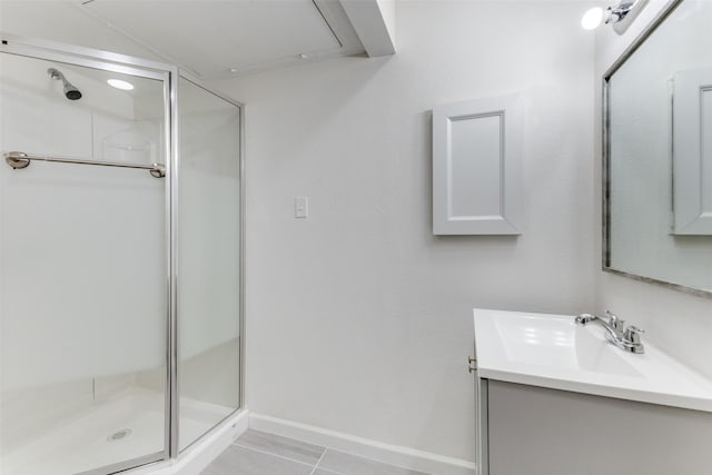 bathroom with tile patterned floors, vanity, and a shower with shower door