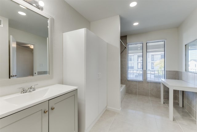 bathroom featuring vanity, a tub to relax in, and tile patterned floors