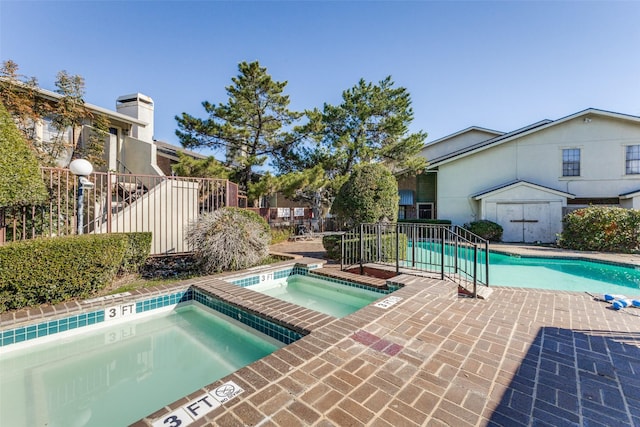 view of pool featuring a hot tub and a storage shed