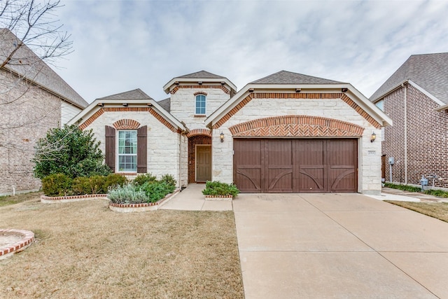 view of front of house featuring a front yard and a garage