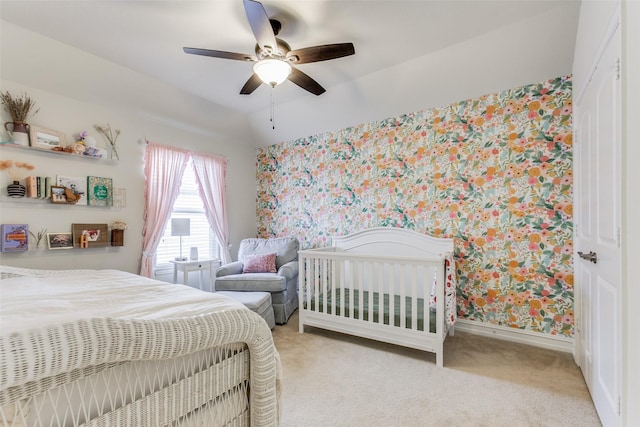 bedroom featuring light colored carpet, vaulted ceiling, and ceiling fan