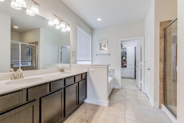 bathroom with tile patterned flooring, vanity, and an enclosed shower