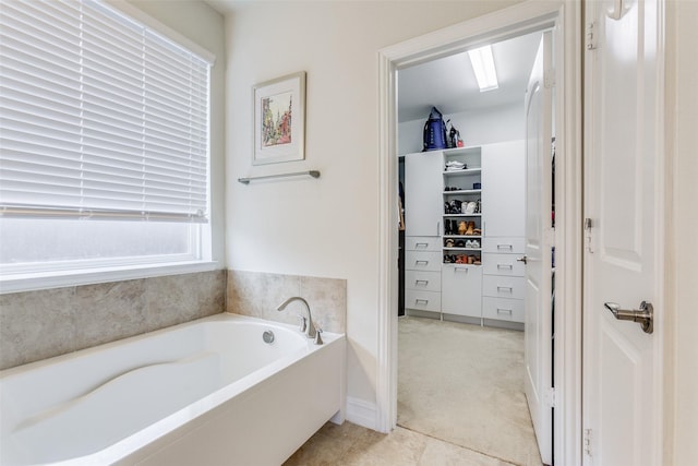 bathroom with tile patterned floors and a washtub