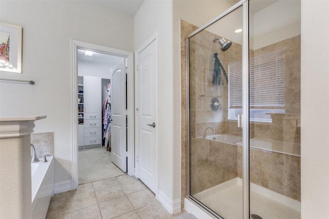 bathroom with tile patterned flooring and separate shower and tub