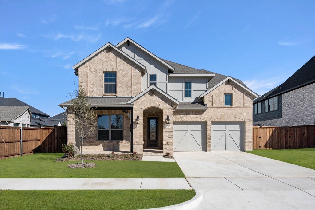 craftsman-style house with a front yard and a garage