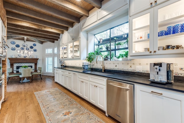 kitchen with wooden ceiling, white cabinetry, stainless steel dishwasher, sink, and beam ceiling