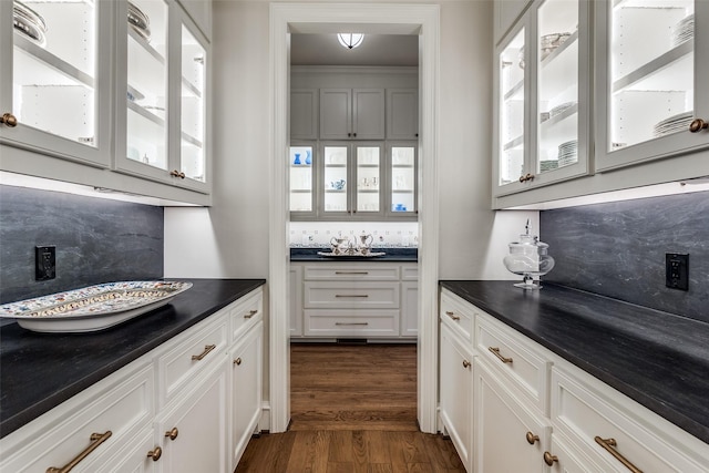 kitchen with white cabinetry, decorative backsplash, a wealth of natural light, and dark hardwood / wood-style floors