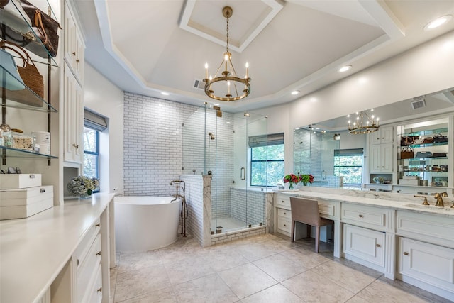 bathroom with tile patterned floors, vanity, an inviting chandelier, a raised ceiling, and plus walk in shower