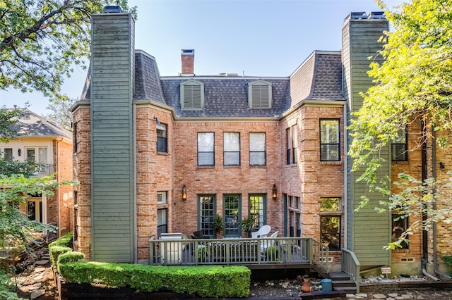 rear view of property with a wooden deck