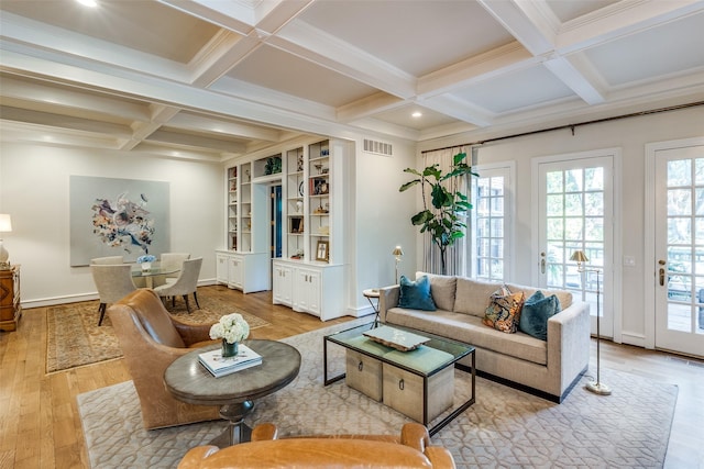 living room featuring coffered ceiling, light hardwood / wood-style flooring, beamed ceiling, and ornamental molding