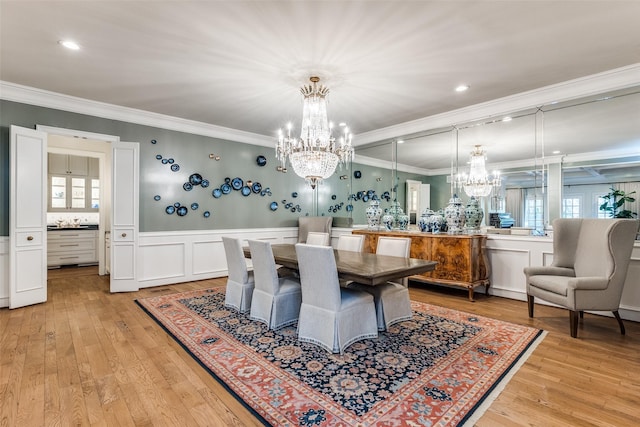 dining area featuring a notable chandelier, crown molding, and light hardwood / wood-style floors