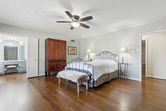 bedroom with ceiling fan with notable chandelier and dark hardwood / wood-style floors