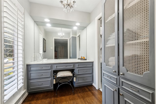 bathroom featuring hardwood / wood-style flooring, vanity, and a chandelier