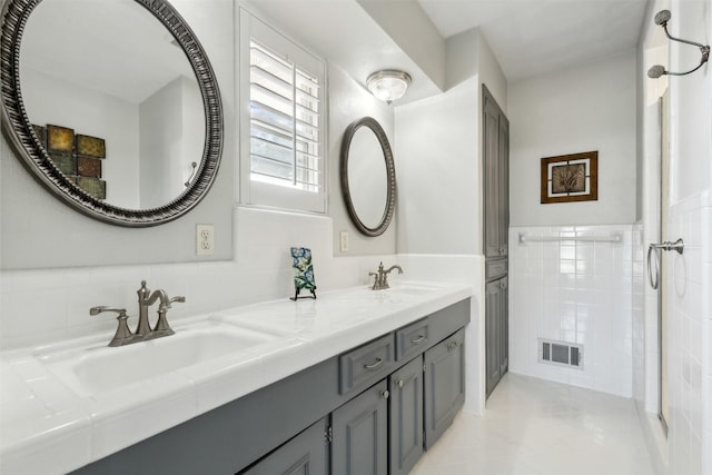 bathroom featuring tile walls, tile patterned floors, and vanity