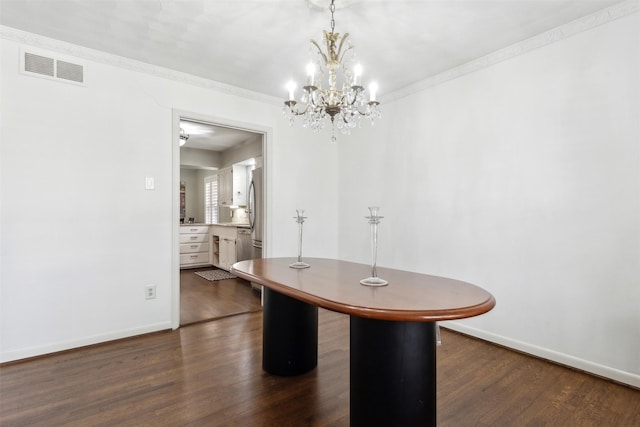 unfurnished dining area featuring dark hardwood / wood-style floors and a notable chandelier