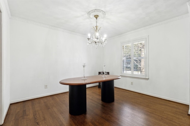 unfurnished office featuring dark hardwood / wood-style flooring, crown molding, and a notable chandelier