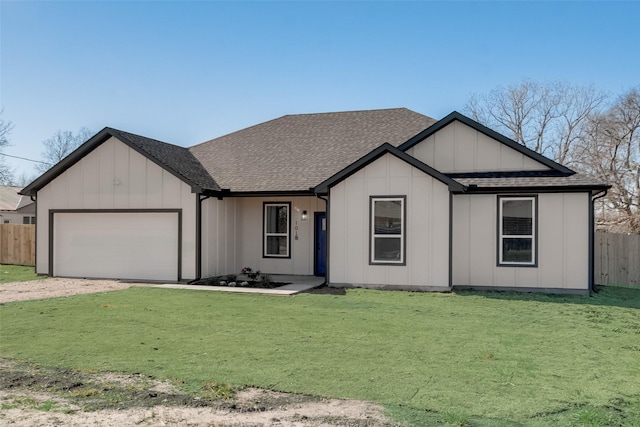 view of front of house featuring a front lawn and a garage