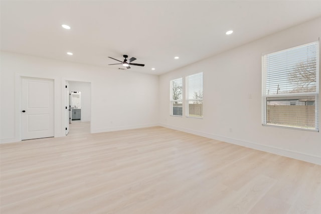 spare room with light wood-type flooring and ceiling fan