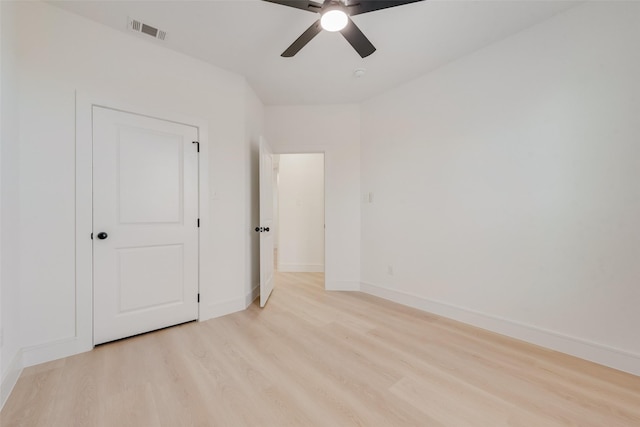 unfurnished bedroom with ceiling fan and light wood-type flooring