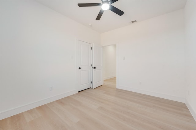 empty room featuring ceiling fan and light wood-type flooring