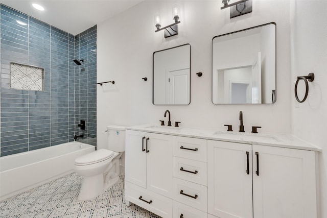 full bathroom featuring vanity, tiled shower / bath combo, and toilet