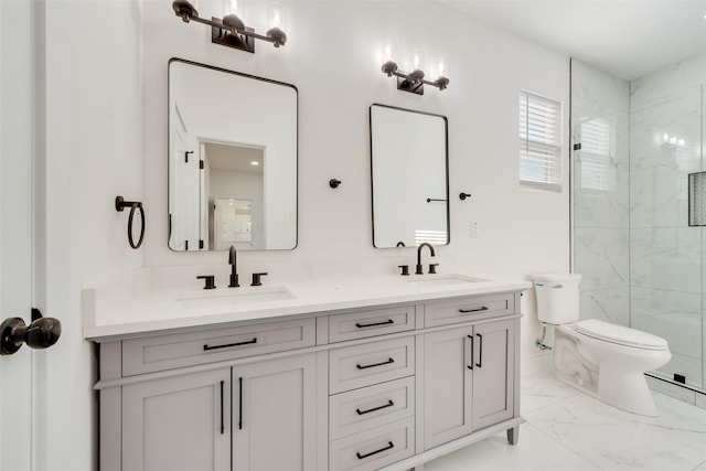 bathroom featuring a shower with door, vanity, and toilet