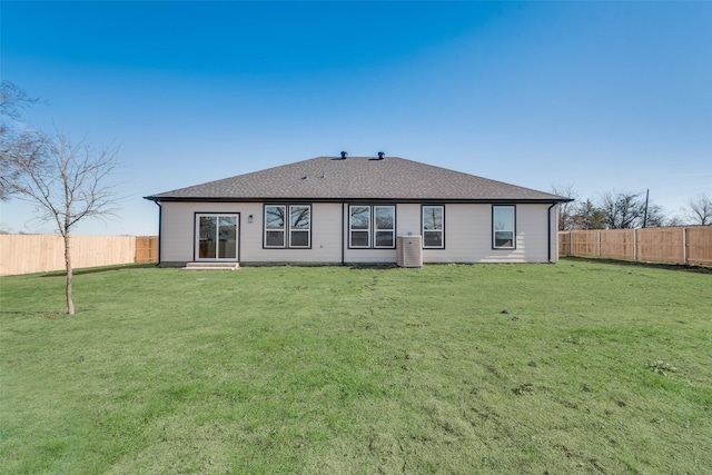 rear view of house featuring a yard and central AC