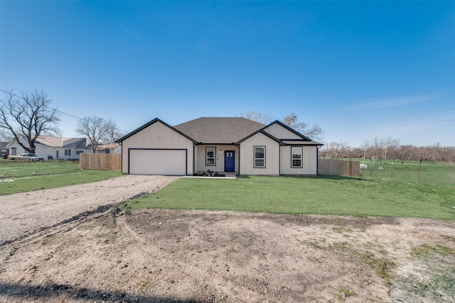 view of front of house with a garage and a front yard